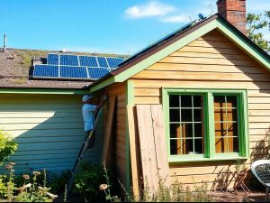 Casă renovată ecologic cu panouri solare, acoperiș verde și bambus.