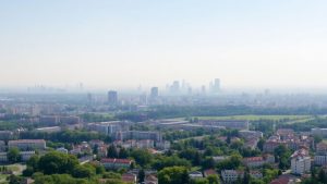 Oraș românesc cu smog și zone verzi.